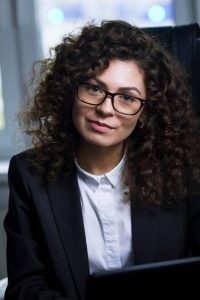 young-woman-with-curly-hair-business-attire-office_254309-1016